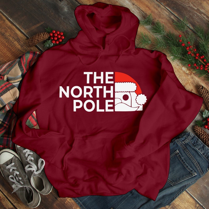 HOODIES (5226 ) The NORTH Pole Merry Christmas Xmas Santa Elf Christmas -Youth Hoodies No drawstring to conform to EU regulations.